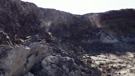 sulfuric steam gases from between rocks of an active volcanic lava field near grindavik, iceland