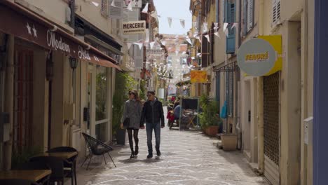 romantic couple walking through a charming street in a french town
