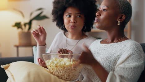 friends on sofa with popcorn, watching tv