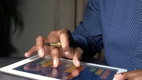 person using tablet with graphs