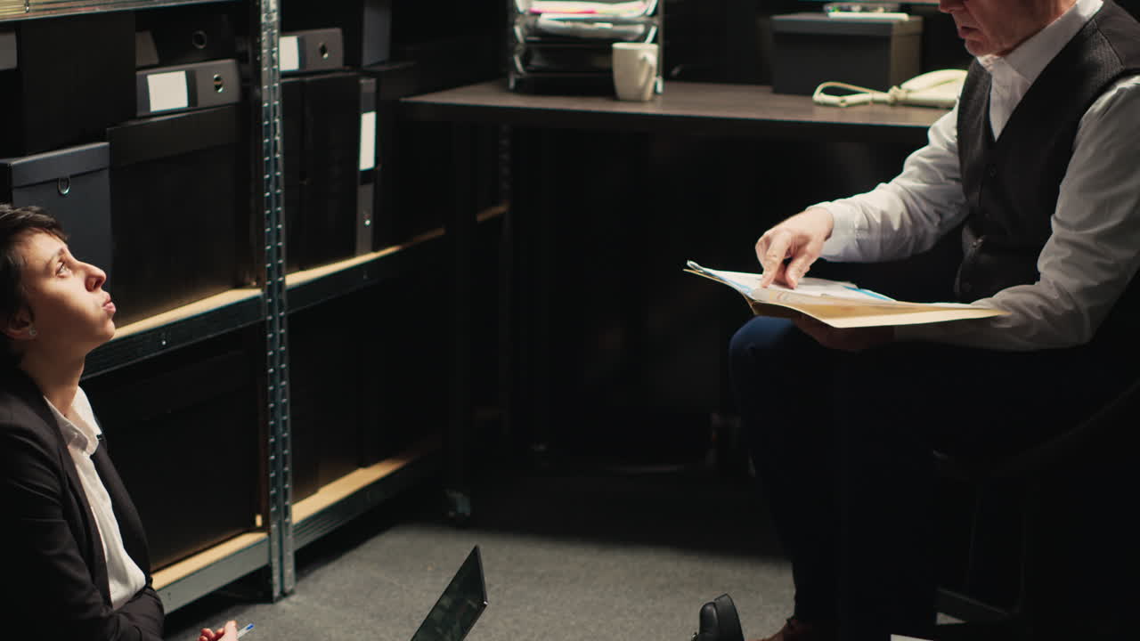Two investigators working on a case in an office