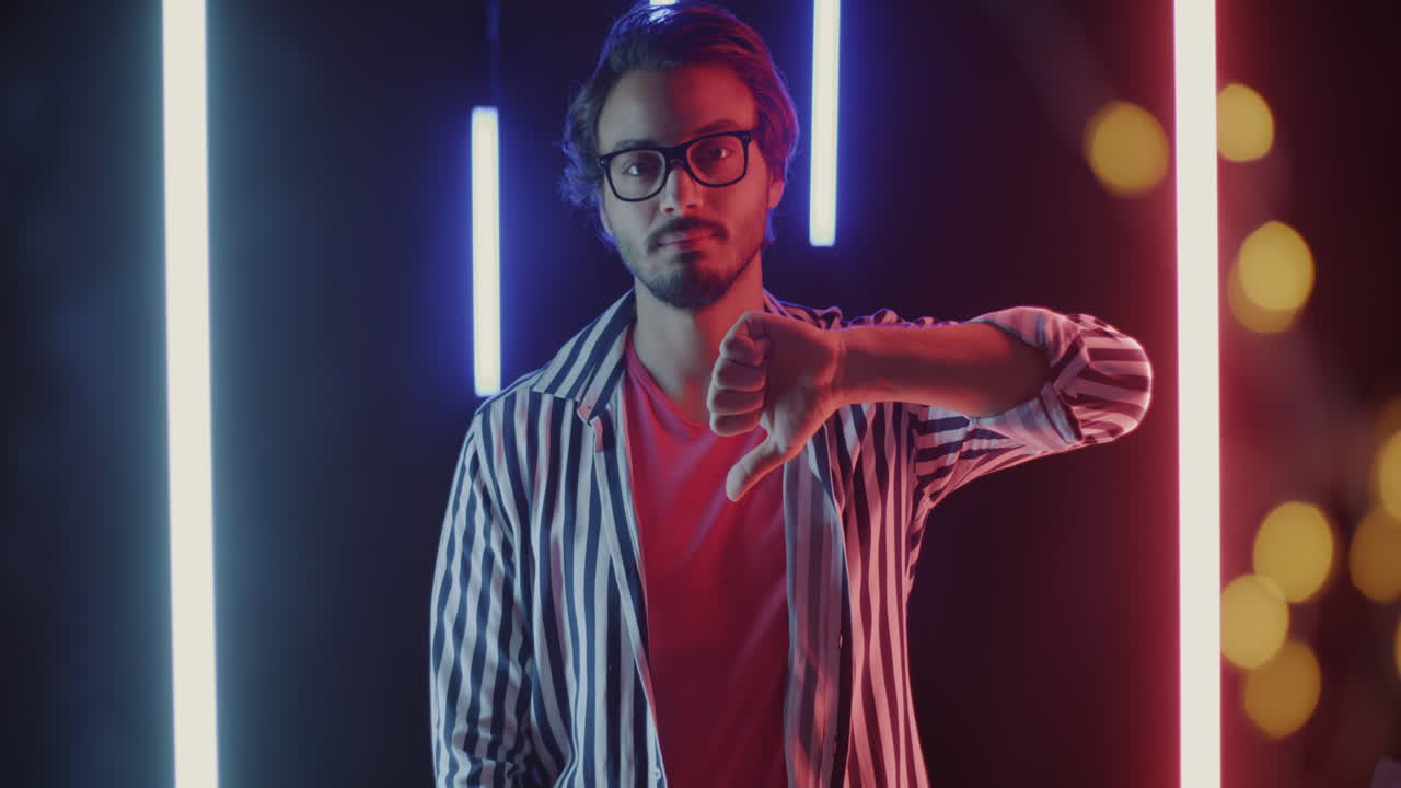Man Giving Thumbs Down in Neon Light