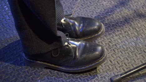 musician dancing on stage , close up shot of his shoes