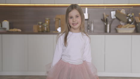 little daughter dressed as princess posing at home