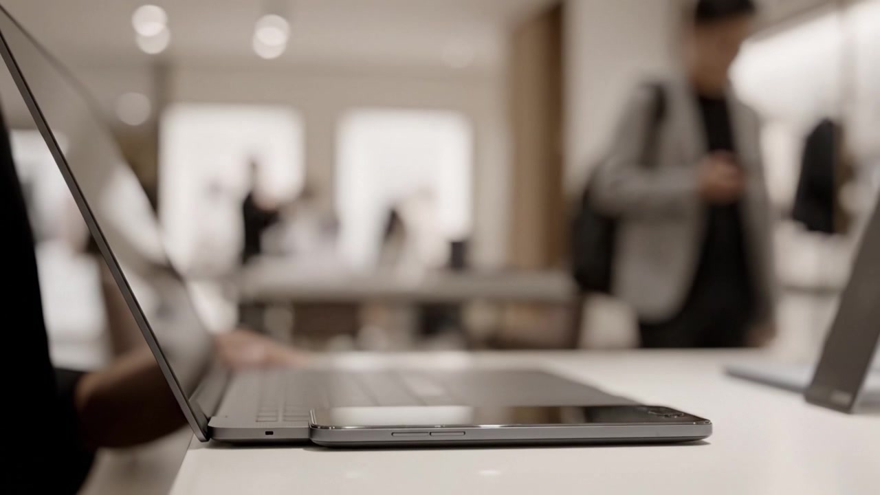 An elegant close-up view of a sleek laptop positioned on a minimalist desk in a modern workspace, showcasing the blend of technology and contemporary design.