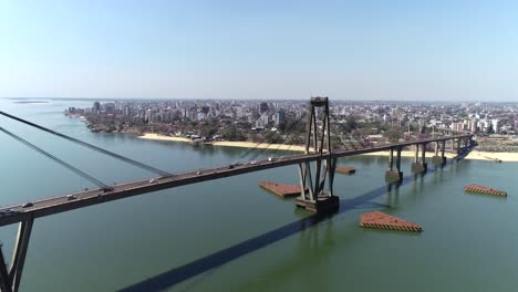 Bird's-eye-view-of-the-Puente-General-Manuel-Belgrano,-the-Paraná-River,-and-the-city-of-Corrientes-in-the-background