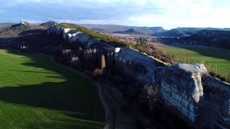 aerial view of a rocky cliff face and surrounding landscape