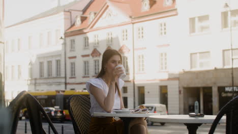 Young-fashionable-woman-sitting-outdoors