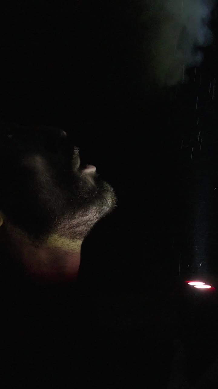 Bearded Man Gazing at Sparks in the Dark Night