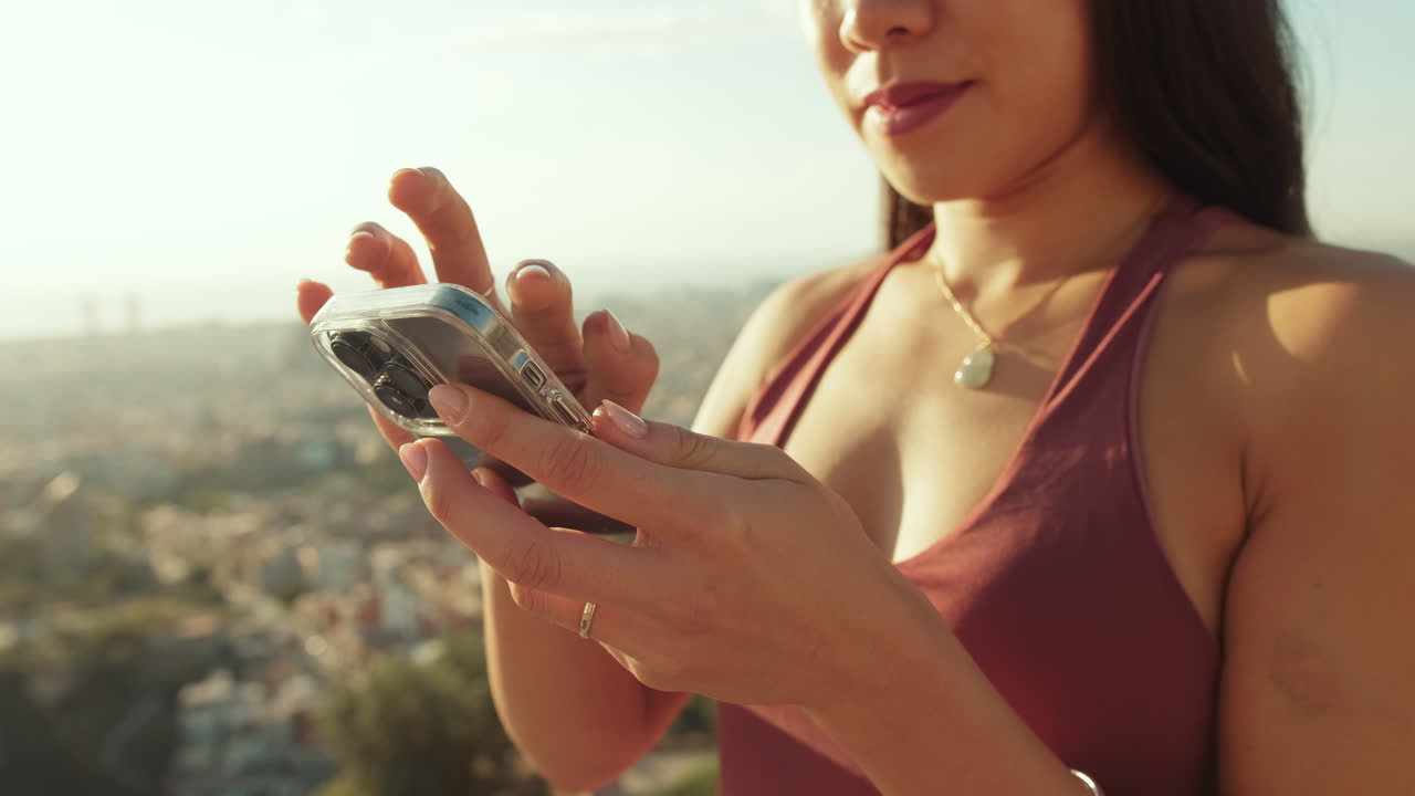 Woman using mobile phone with cityscape view