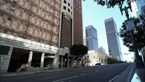 timelapse. freeway traffic in downtown los angeles. shadows on the brick wall of a high-rise building.