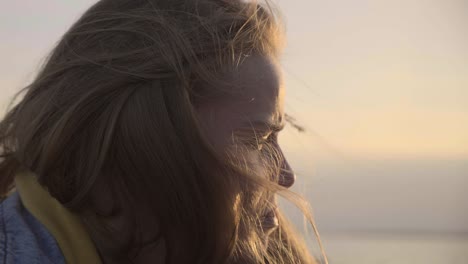 the face portrait of unhappy adult girl at sunset