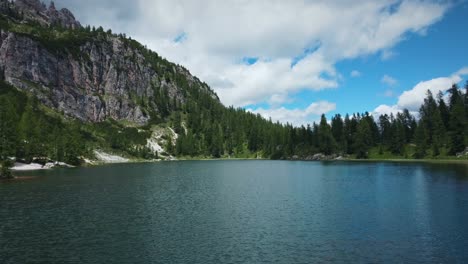 crystal clear water of cortina lake with stunning mountains, croda da lago, italy