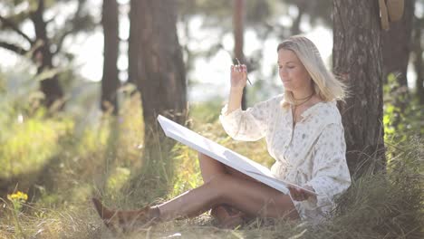 woman painting art outdoors in nature