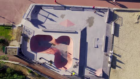 several skaters playing in a skatepark, aerial view, down shot