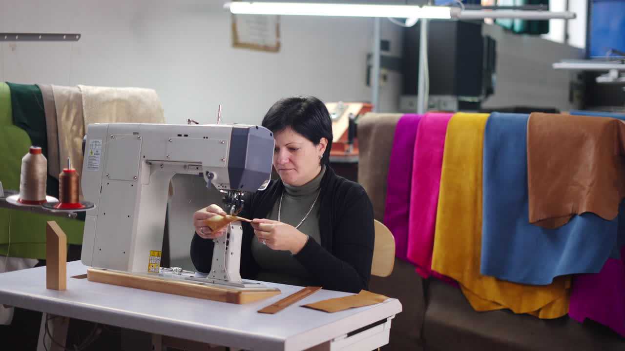 Woman working with leather using a sewing machine