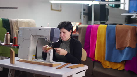 woman working with leather using a sewing machine
