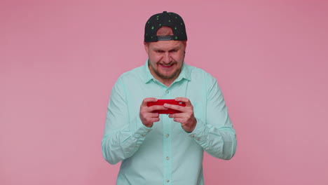 worried funny addicted tourist guy enthusiastically playing drive racing video games on mobile phone