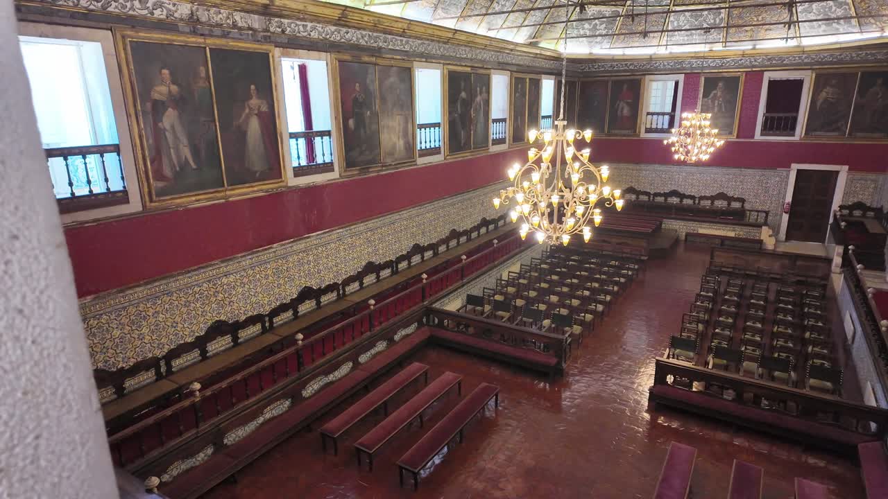 Historic ornate hall with chandeliers and paintings inside Quinta da Regaleira in Sintra, Portugal