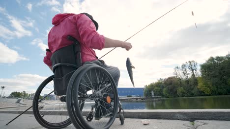 person with a physical disability who uses wheelchair fishing from fishing pier