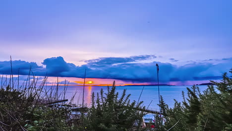 toma de lapso de tiempo del paisaje de la playa con nubes azules en el fondo sobre el mar en una noche nublada