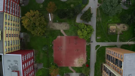 aerial top drone shot of empty kids playground in the middle of city during cloudy day