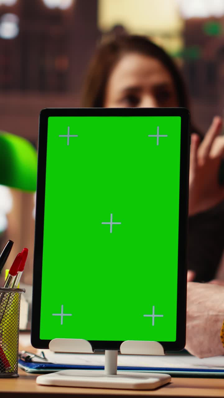 Vertical Video Mature colleagues team review paperwork next to chroma key mockup