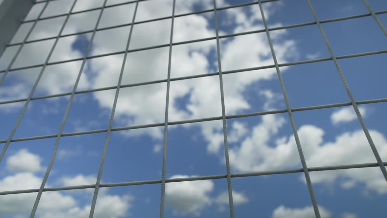 Fence against the blue sky, slow motion; 50 fps slowed to 25