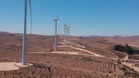 aerial footage of eolic turbines, side view