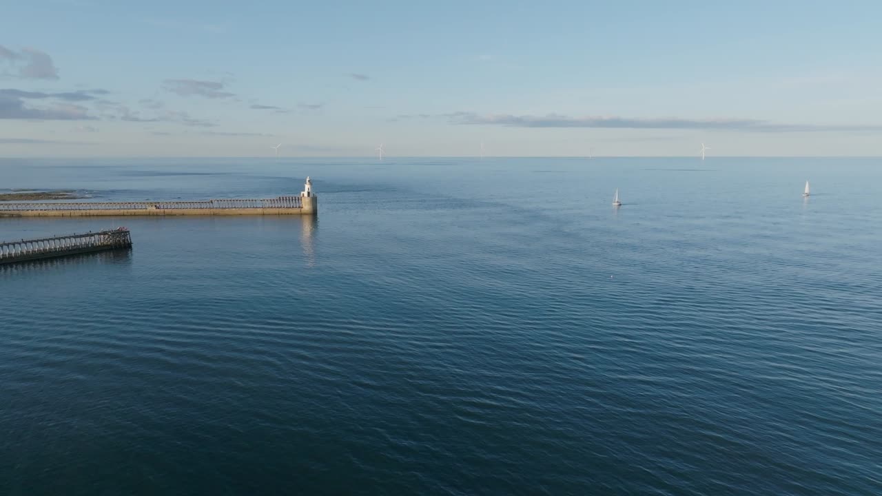 Drone clip showing natural patterns of water movement and sea currents around a harbour
