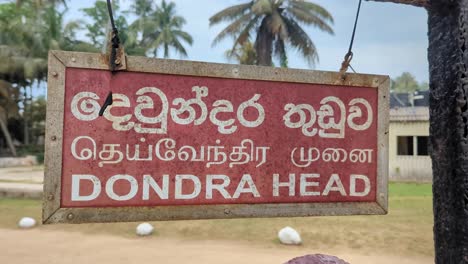 closeup of dondra head lighthouse sign at southernmost point in english, tamil, and sinhala languages
