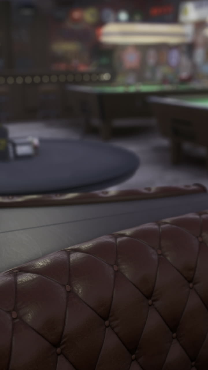 Cozy game room with plush seating and pool tables under soft lighting