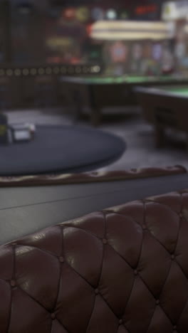 cozy game room with plush seating and pool tables under soft lighting