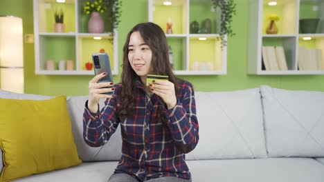 asian young woman shopping online from credit card.