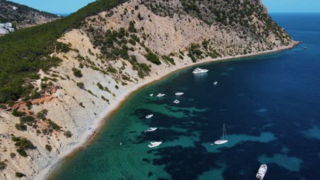 A-lot-of-sailing-boats-and-yachts-achored-around-the-coast-of-Amante,-Ibiza,-Spain