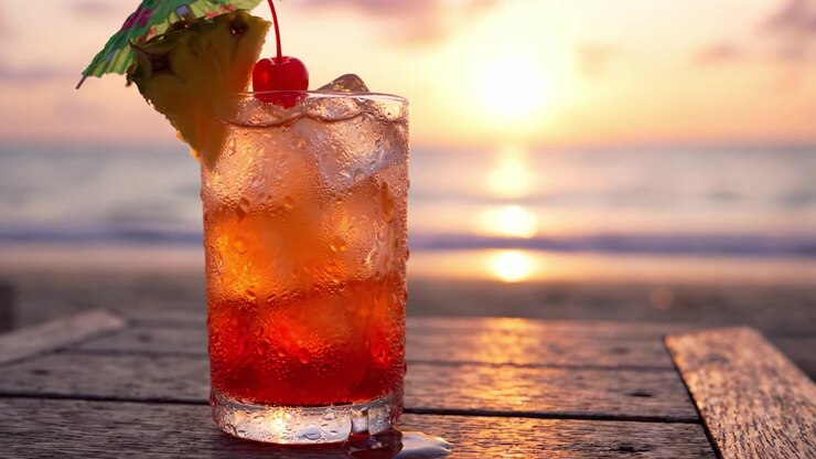 A Refreshing Cocktail by the Beach at Sunset, with Vibrant Colors Reflecting the Warmth of the Evening, Perfect for Relaxation and Enjoying Nature's Beauty