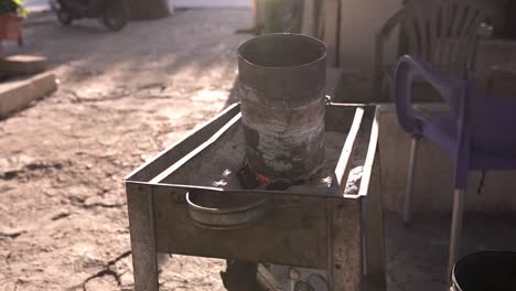 Old-metal-barrel-on-sand-brazier-on-street