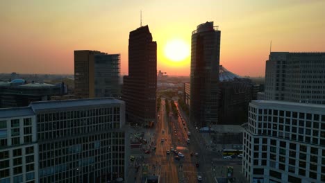 berlin potsdamer platz skyline during golden hour sunset with traffic flowing on roads. beautiful aerial view flight drone shot footage from above