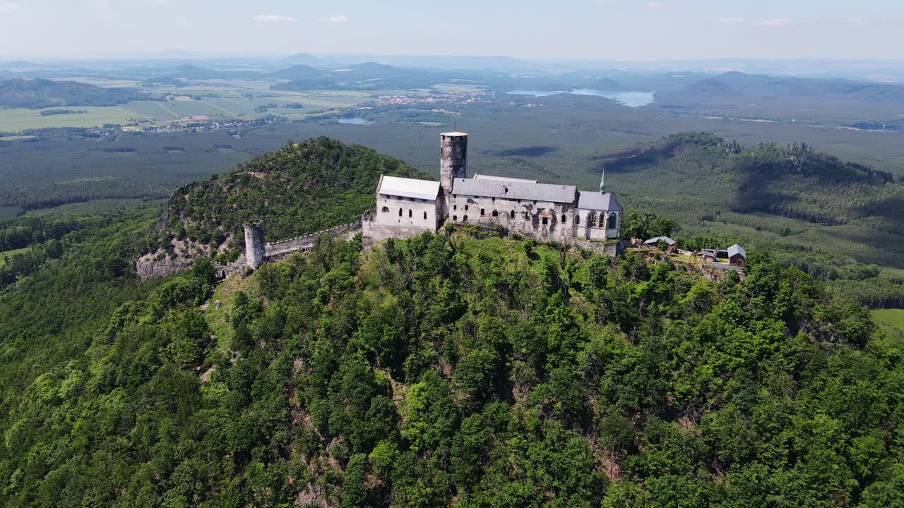 Aerial view of Bezděz fortress rising high above surrounding Czech landscape