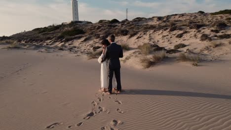 loving bride and groom enjoying romantic moment on sandy shore