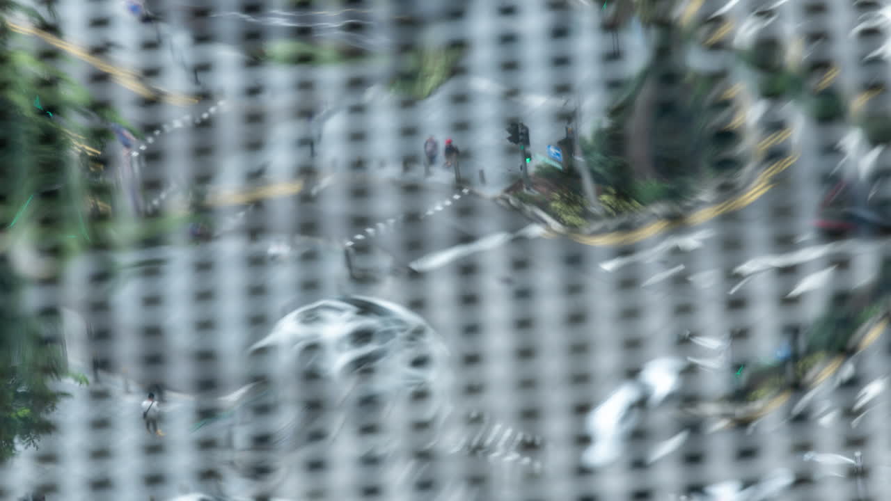 traffic on road in singapore reflected in mirrored roof of building