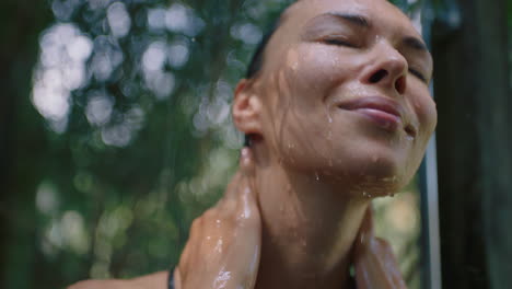 sexy woman in shower wearing bikini washing body cleansing skin with refreshing water enjoying natural beauty spa showering outdoors in nature