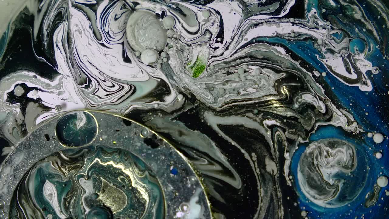 Black, white and blue space acrylic chemical reaction. Slow motion.