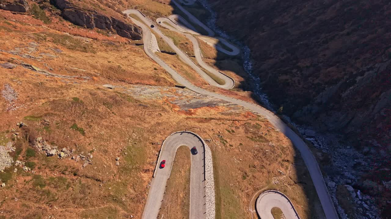 Elevated view of Tremola’s winding path and car driving, Switzerland