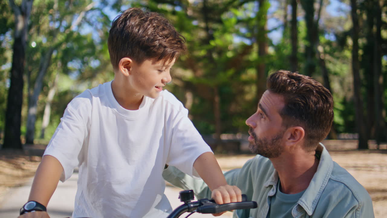 Man boy communicating sunlight forest closeup. Smiling father talking to son