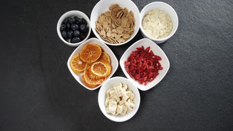 bowl of dried orange slices, blueberries and breakfast cereals 4k