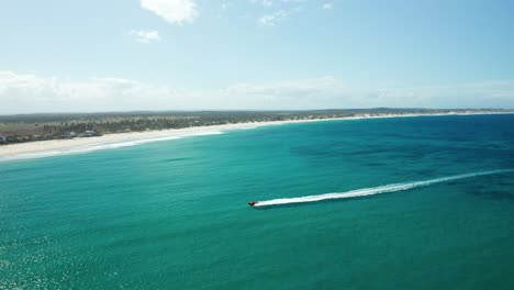 Totale-Von-Einer-Drohne,-Die-Ein-Schnellboot-Verfolgt,-Das-In-Richtung-Strand-In-Tofo,-Mosambik,-Fährt