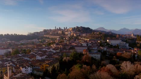 autumnal flyover of bergamo bassa to approach the hill of bergamo alta