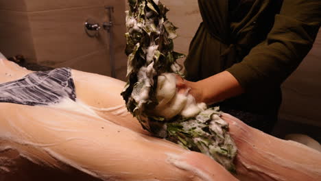 Woman receiving a spa body scrub