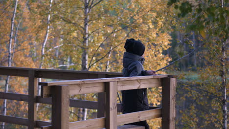 Young-boy-in-viewpoint-tower-looking-out-over-beautiful-autumn-landscape